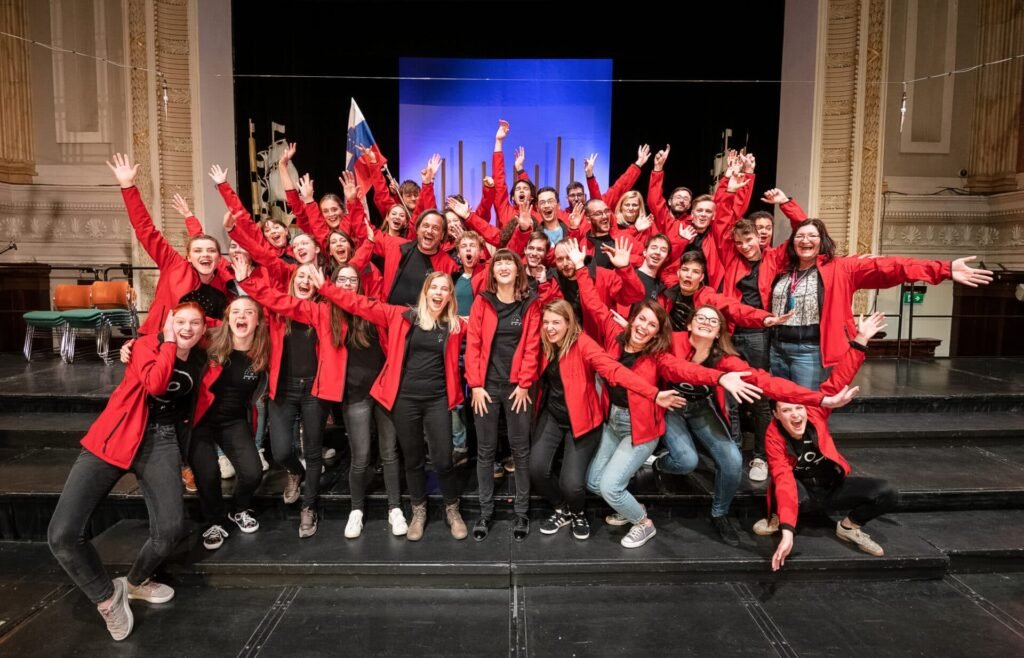 A choir celebrating on stage at Cork International Choral Festival